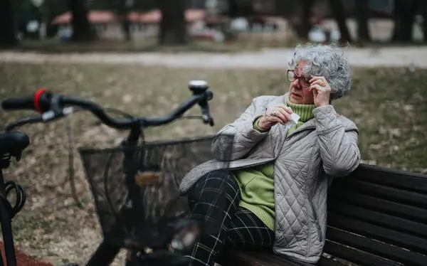Madura Jubilada Tomando Descanso Del Ciclismo Sentada Banco Parque Ajustando —  Fotos de Stock