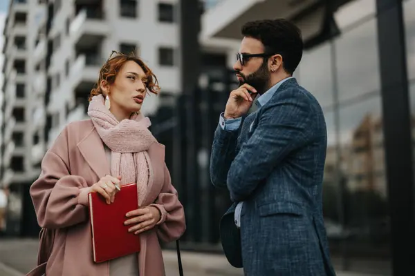 stock image Young professionals engage in a strategic business meeting outdoors with city backdrop