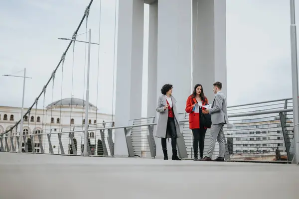 Trio Business Professionals Engaged Conversation Modern Bridge Urban Landscape Background — Stock Photo, Image