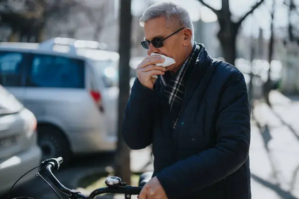 Mature Man Wearing Winter Jacket Sunglasses Stands Urban Street Blowing — Stock Photo, Image