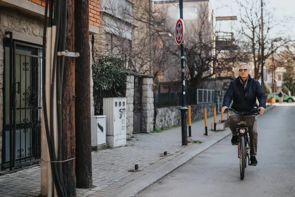 An older gentleman cycles down a peaceful street, embracing active lifestyle and urban cycling. A candid moment of everyday life, senior mobility and healthy habits captured.