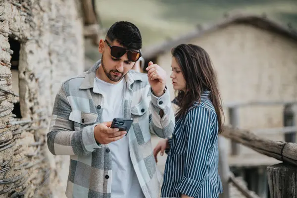 Young Couple Using Mobile Phone Holidays Navigating Historical Village Location — Stock Photo, Image