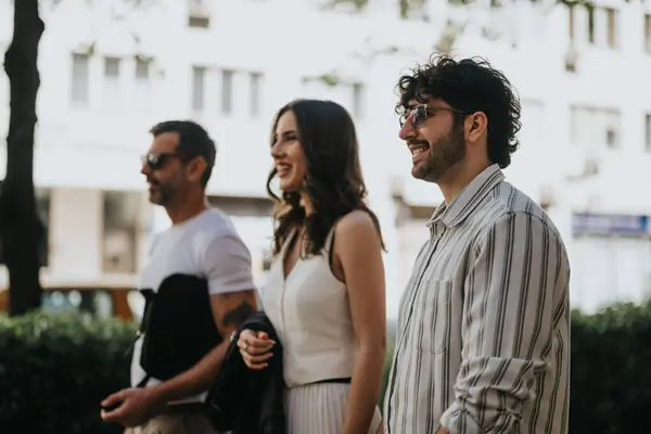 stock image A group of multi-generational business executives in casual attire meeting outdoors in a bustling cityscape.