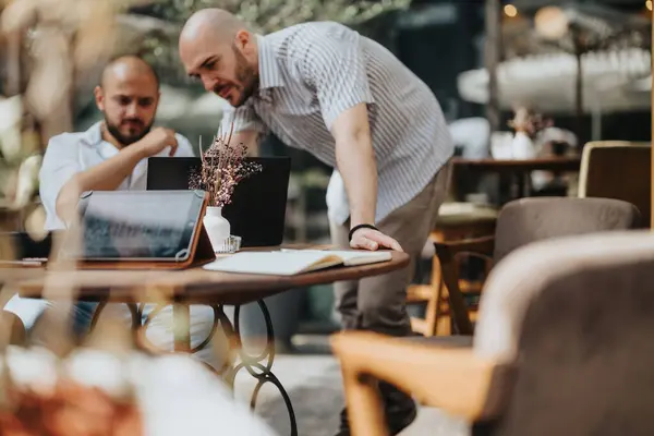 stock image Young business entrepreneurs strategizing and collaborating on a project in a casual setting, demonstrating teamwork for business improvement and growth.