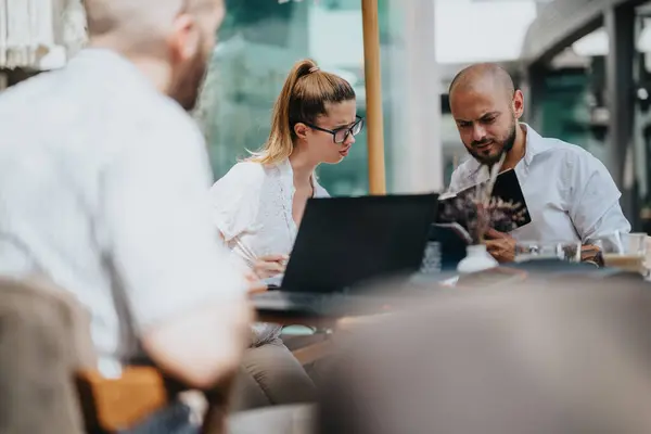 stock image Startup team in an outdoor business meeting, discussing strategies, brainstorming ideas, and analyzing data for project development and planning.