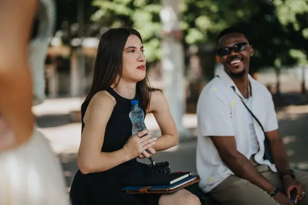 stock image Multicultural businesspeople in an outdoor meeting discussing business in the city. Mixed race people collaborating in a casual urban environment.