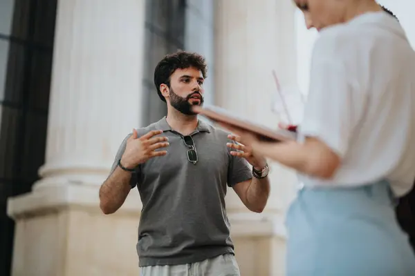 stock image Two professionals engaged in an outdoor meeting in an urban city environment focusing on collaboration and discussion.