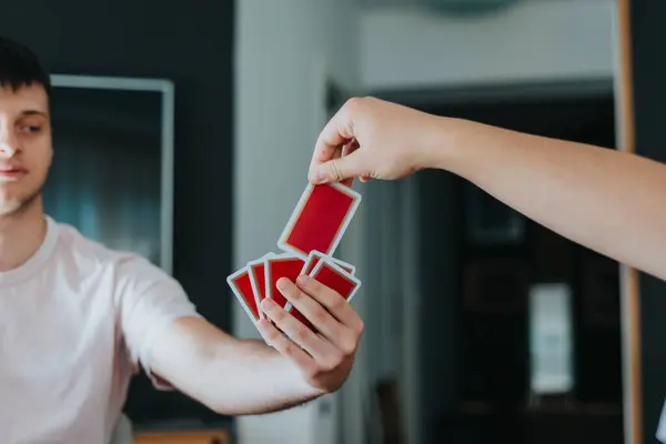 stock image Family enjoying quality time playing cards together at home, fostering fun and connection.