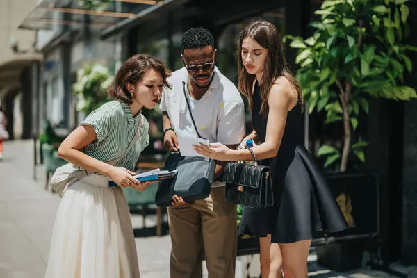 stock image Diverse business partners analyze and discuss financial statistics in an outdoor meeting, focusing on market growth and teamwork.