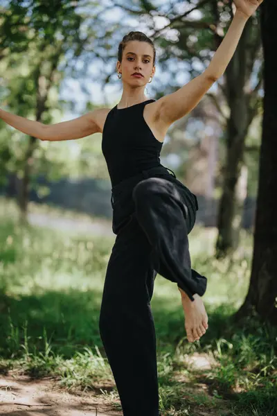 stock image Girl performing modern dance moves in a natural outdoor setting, expressing grace and elegance.