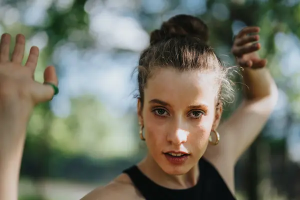 stock image Gorgeous girl performing modern dance on a sunny day in an urban park environment, showcasing expressive movement and focus.