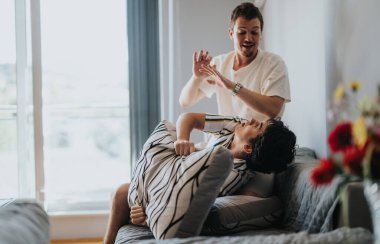 Two friends engage in a playful pillow fight, sharing laughter and joy in a cozy living room setting. Capturing the essence of fun and friendship during leisure time. clipart