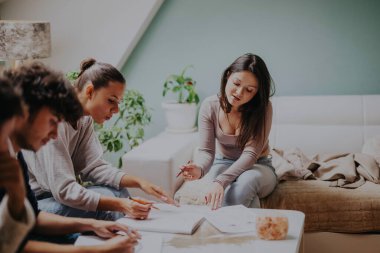 High school students collaborate on a project with their professor in a cozy home setting. They focus intently, using notes and resources to complete their school assignments after class. clipart