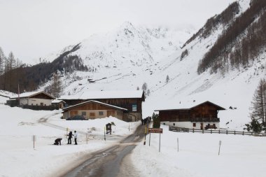 PRASTMANN, ITALY - DECEMBER 29, 2022: Panoramic view of Prastmann alpine village with snow during winter season with tourist, Valle Aurina, Italy