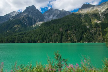 Güney Tyrol, İtalya 'da zümrüt suyu olan güzel bir göl olan Antholz Gölü manzarası.