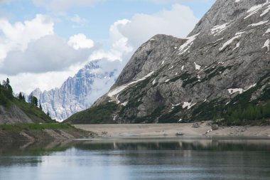 Panoramic view of Lago di Fedaia beautiful lake on the background of the Marmolada massif clipart