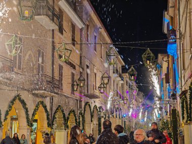 FOSSOMBRONE, ITALY - DECEMBER 15, 2024: Old street of Fossombrone at christmas time with many tourist in the Marche region, Italy clipart