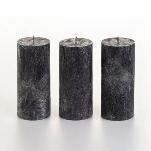 stock image Set of four black palm wax candles with unique ice-like patterns arranged on white background. Concept of stylish handcrafted accessories adding modern touch to home or office decor