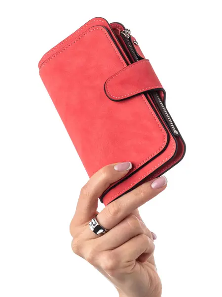 stock image Close-up of female hand elegantly holding textured vibrant red suede wallet with multiple compartments isolated against white background. Concept of brightness and individuality in personal style