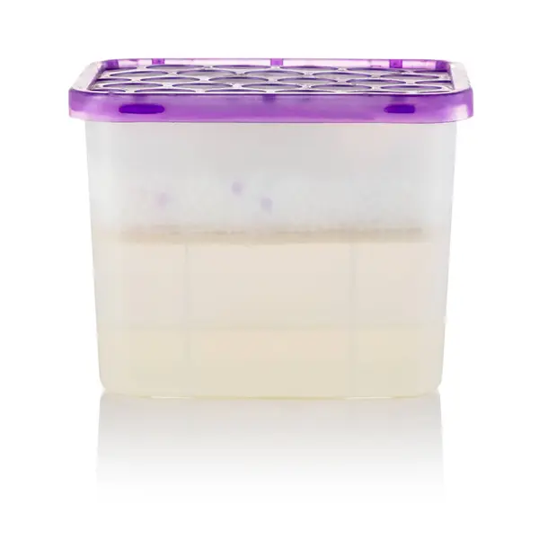 stock image Moisture absorber half filled with hygroscopic granules visible through semi-transparent brown container, with vented pink lid on top and clean label area for branding or product informatio