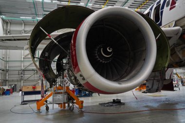 Astana, Kazakistan - 10.17.2022: Mühendisler hangardaki Fly Arystan Airbus A320 uçağının yedek parçalarının onarımı ve teşhisini gerçekleştirdiler