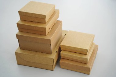 Cardboard boxes for gifts, parcels, delivery of goods are stacked on the table