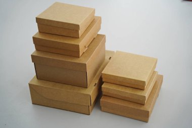 Cardboard boxes for gifts, parcels, delivery of goods are stacked on the table