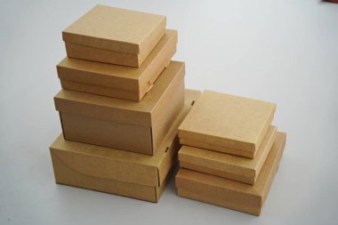 Cardboard boxes for gifts, parcels, delivery of goods are stacked on the table