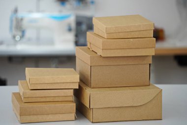 Cardboard boxes for gifts, parcels, delivery of goods are stacked on the table