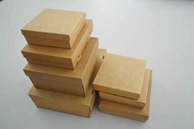 Cardboard boxes for gifts, parcels, delivery of goods are stacked on the table