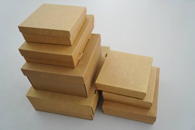 Cardboard boxes for gifts, parcels, delivery of goods are stacked on the table