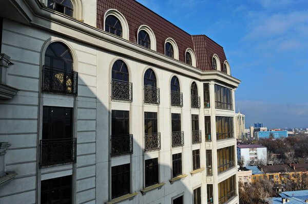 Almaty, Kazakhstan - 11.23.2015 : View of the windows of a multi-storey residential complex and the adjacent driveway.