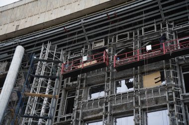 Almaty, Kazakhstan - 03.30.2023 : Reconstruction of the facade of the City Hall after the riots clipart