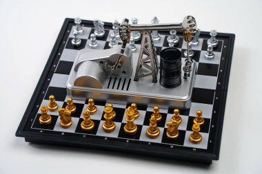 Parçalı bir satranç tahtası, yağ pompası valesi ve yağ varilleri. Strateji, iş dünyası, siyasi oyun ve diplomasi.