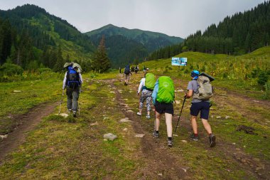 Almaty, Kazakistan - 07.11.2025: Turistler Ile-Alatau Milli Parkı 'nda yürüyüş yapıyorlar. Almaty yakınlarında farklı bitki örtüsü olan dağlık bir bölge. Tian Shan Dağları.
