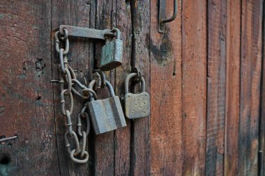 The lock on the old wooden door of the garage and barn.