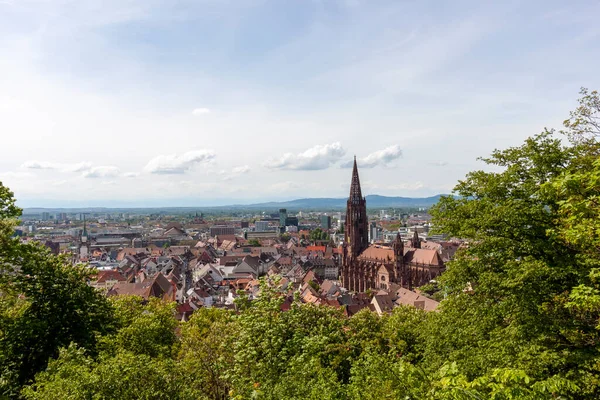 stock image FREIBURG, GERMANY - MAY 6, 2023: View over Freiburg Minster from slope of Schlossberg Hill. The cathedral was founded around 1200 and completed in 1330