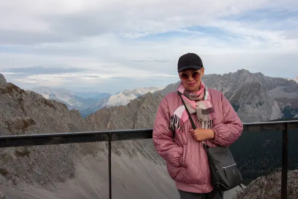 A mature woman on the top of Nordkette above the abyss. Austria, top of Innsbruck