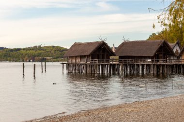 Stilt houses (Pfahlbauten), Stone and Bronze age dwellings in Unteruhldingen town, Lake Constance (Bodensee), Baden-Wurttemberg state, Germany clipart