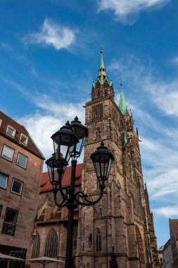 Street lights against the backdrop of St. Lorenz Cathedral in Nuremberg, Bavaria clipart