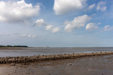 Grimmershorner Bay in Cuxhaven on the North Sea with a bathing beach. The sea is at low tide clipart