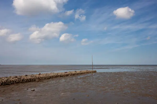 stock image Grimmershorner Bay in Cuxhaven on the North Sea with a bathing beach. The sea is at low tide