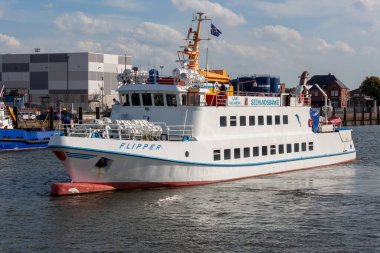 CUXHAVEN, GERMANY - AUGUST 15, 2024: Cassen Eils tourist steamer FLIPPER in the port of Cuxhaven clipart