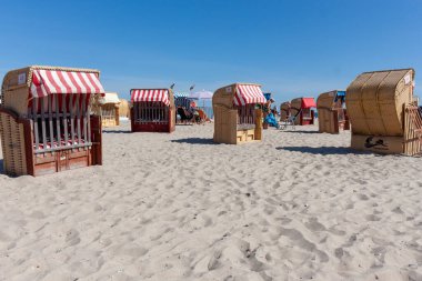 TRAVEMUNDE, GERMANY - 13 Ağustos 2024: Gezgin 'deki Baltık Denizi' ndeki sahil sandalyeleri