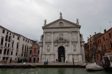 VENICE, ITALY - OCTOBER 24, 2024: A photograph of the white facade of the San Stae church with sculptures and the central entrance clipart