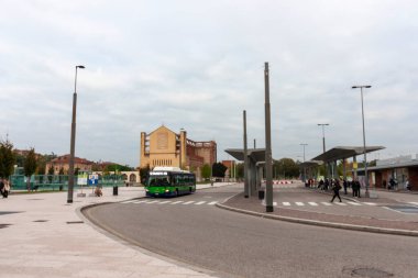 VERONA, ITALY - OCTOBER 22, 2024: The square in front of Verona Porta Nuova train station, Italy, with a city bus and the Tempio Votivo church in the background clipart