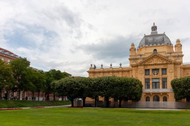 ZAGREB, CROATIA - 22 Mayıs 2025: Hırvatistan 'ın Zagreb kentindeki görkemli Sanat Pavyonu bulutlu bir gökyüzünün altında görkemli bir şekilde duruyor