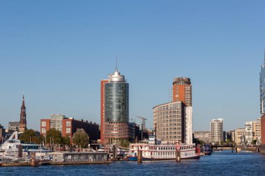 HAMBURG, GERMANY - 12 AĞUSTOS 2024: Hamburg, Almanya kıyı şeridinin panoramik bir görüntüsü, modern yüksek binalar ve klasik mimari tarzlarla dolu bir şehir silueti sergiliyor