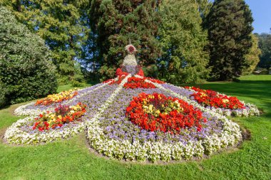 The magnificent peacock made of flowers at the famous Mainau Island garden on Lake Constance, showcasing vibrant colors and stunning horticultural art under a clear blue sky