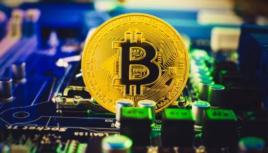 Blockchain technology bitcoin mining concept. Bitcoin golden coin on computer circuit board. banner copy space